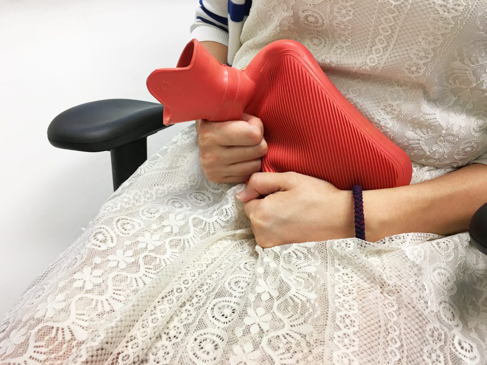 hot water bottle on womans belly kenny-wong unsplash